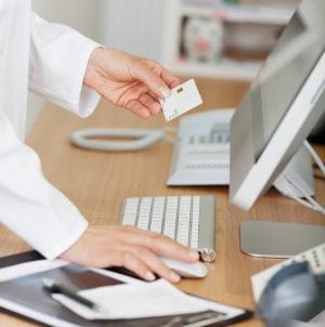 woman entering patient information into a computer